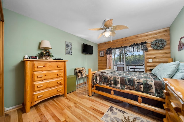376 Highview Rd, Traverse City, MI 49696 - bedroom with rustic walls, light wood finished floors, baseboards, access to outside, and a ceiling fan