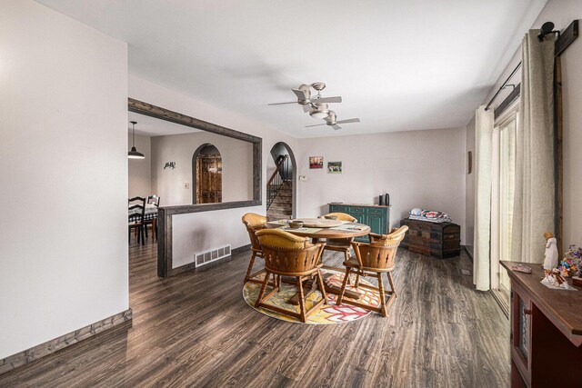 608 N Wickshire Ln, Durand, MI 48429 - dining area with wood finished floors, arched walkways, ceiling fan, and baseboards