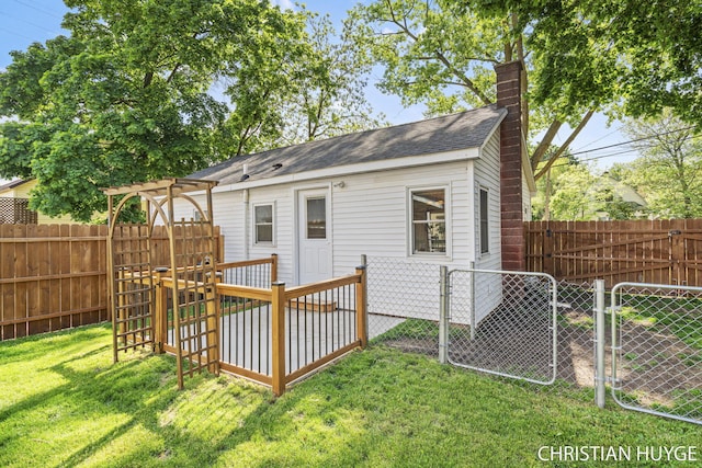 180 Maple St, Sparta, MI 49345 - rear view of house featuring a chimney, a gate, and a shingled roof