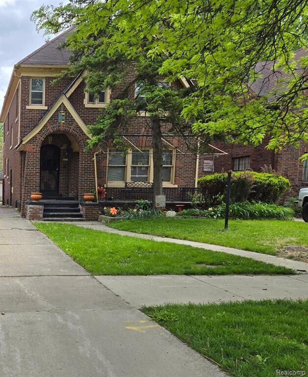 4277 Fullerton Ave, Detroit, MI 48238 - tudor-style house with brick siding and a front lawn