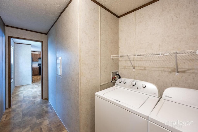 229 Spear St SW, Grand Rapids, MI 49548 - laundry area featuring washing machine and clothes dryer, a textured ceiling, stone finish flooring, and crown molding