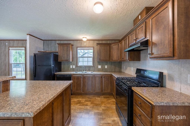 229 Spear St SW, Grand Rapids, MI 49548 - kitchen featuring black appliances, under cabinet range hood, a sink, plenty of natural light, and a textured ceiling