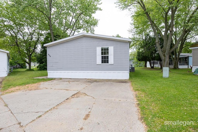 229 Spear St SW, Grand Rapids, MI 49548 - view of home's exterior featuring a yard and central air condition unit