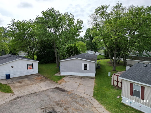 229 Spear St SW, Grand Rapids, MI 49548 - view of green lawn with an outbuilding and view of wooded area