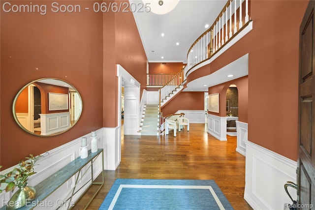 6212 Bromley Ct, West Bloomfield, MI 48322 - entrance foyer featuring a decorative wall, a wainscoted wall, stairway, wood finished floors, and a towering ceiling
