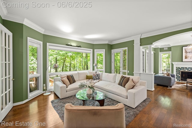 6212 Bromley Ct, West Bloomfield, MI 48322 - living area with decorative columns, wood-type flooring, crown molding, a fireplace, and arched walkways