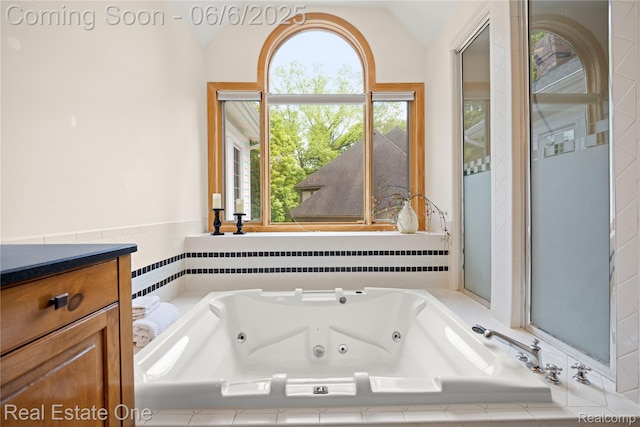 6212 Bromley Ct, West Bloomfield, MI 48322 - bathroom with lofted ceiling, a tub with jets, and vanity