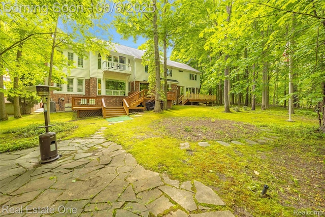 6212 Bromley Ct, West Bloomfield, MI 48322 - view of grassy yard featuring a balcony, a wooden deck, a patio area, and central AC