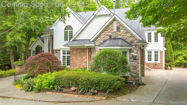6212 Bromley Ct, West Bloomfield, MI 48322 - traditional home featuring stone siding, roof with shingles, and brick siding
