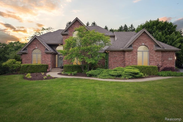3468 High Hillcrest Dr, Howell, MI 48843 - view of front facade featuring brick siding, a lawn, and roof with shingles