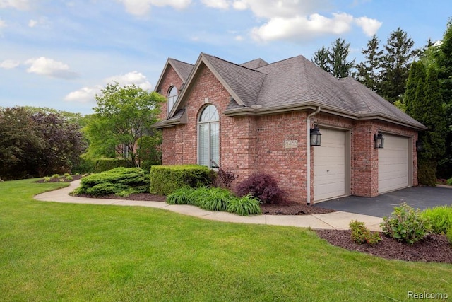 3468 High Hillcrest Dr, Howell, MI 48843 - view of side of home with brick siding, a garage, a lawn, asphalt driveway, and a shingled roof