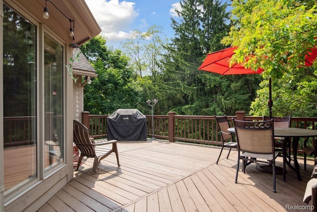 3468 High Hillcrest Dr, Howell, MI 48843 - deck featuring area for grilling, outdoor dining space, and view of wooded area