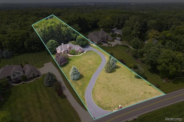 3468 High Hillcrest Dr, Howell, MI 48843 - aerial overview of property's location with a heavily wooded area and property boundaries highlighted