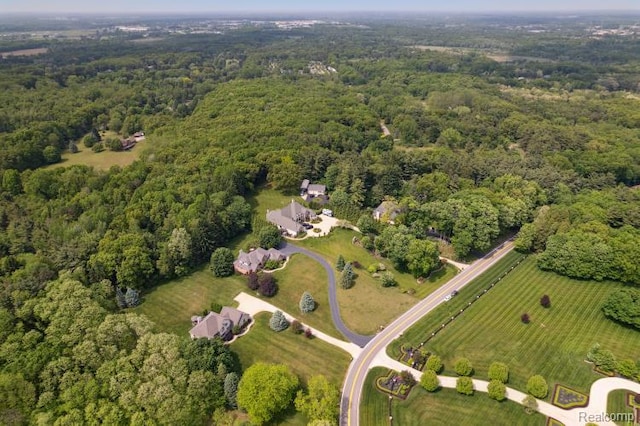 3468 High Hillcrest Dr, Howell, MI 48843 - aerial view of property and surrounding area featuring a heavily wooded area