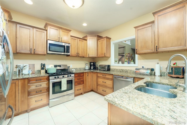 1235 Joann Ln, Williamston, MI 48895 - kitchen with appliances with stainless steel finishes, a sink, recessed lighting, light stone countertops, and light tile patterned floors