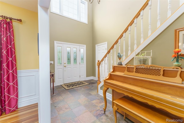 1235 Joann Ln, Williamston, MI 48895 - foyer with stone finish flooring, a high ceiling, and stairs