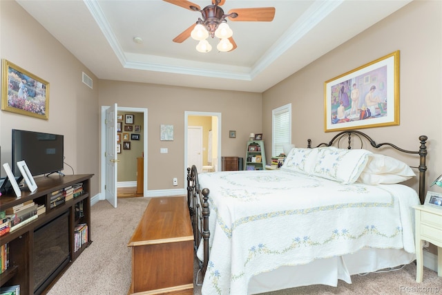 1235 Joann Ln, Williamston, MI 48895 - carpeted bedroom featuring a tray ceiling, baseboards, ornamental molding, ensuite bathroom, and a ceiling fan