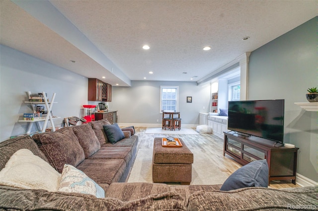 1235 Joann Ln, Williamston, MI 48895 - living area featuring recessed lighting, light wood finished floors, baseboards, and a textured ceiling