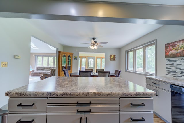 4470 Peach Ridge Ave NW, Grand Rapids, MI 49544 - kitchen featuring dishwasher, healthy amount of natural light, light countertops, and a ceiling fan
