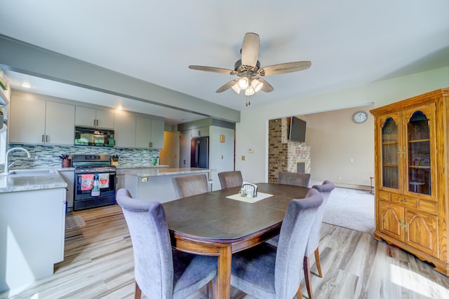 4470 Peach Ridge Ave NW, Grand Rapids, MI 49544 - dining room with light wood-type flooring and a ceiling fan
