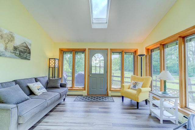 4470 Peach Ridge Ave NW, Grand Rapids, MI 49544 - living room with a baseboard radiator, plenty of natural light, a skylight, wood finished floors, and high vaulted ceiling