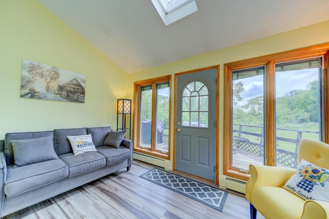 4470 Peach Ridge Ave NW, Grand Rapids, MI 49544 - living room featuring a baseboard radiator, a skylight, wood finished floors, baseboard heating, and high vaulted ceiling