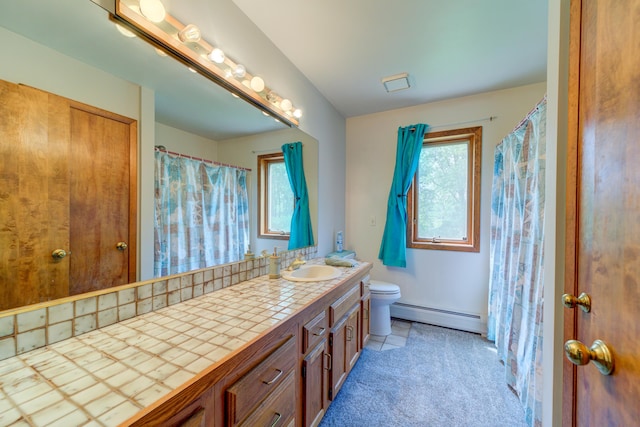 4470 Peach Ridge Ave NW, Grand Rapids, MI 49544 - full bathroom with a baseboard heating unit, toilet, vanity, and plenty of natural light