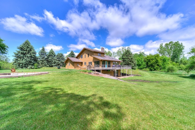 4470 Peach Ridge Ave NW, Grand Rapids, MI 49544 - back of house featuring a wooden deck, a chimney, and a yard
