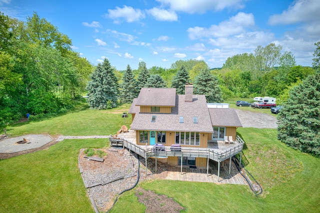 4470 Peach Ridge Ave NW, Grand Rapids, MI 49544 - rear view of property with a wooden deck, a fire pit, a yard, and a chimney
