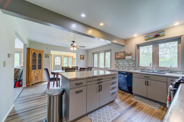 4470 Peach Ridge Ave NW, Grand Rapids, MI 49544 - kitchen featuring dishwasher, a sink, light wood-style floors, a center island, and recessed lighting