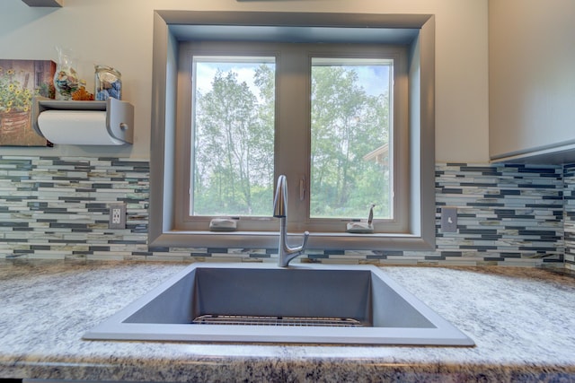 4470 Peach Ridge Ave NW, Grand Rapids, MI 49544 - kitchen with a sink, backsplash, and light countertops