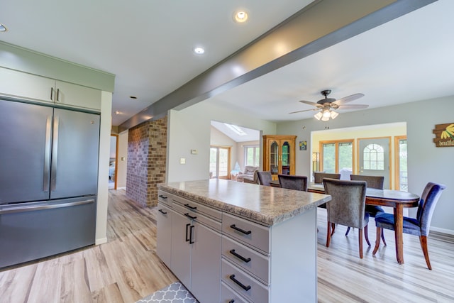 4470 Peach Ridge Ave NW, Grand Rapids, MI 49544 - kitchen featuring stainless steel refrigerator, a center island, light wood-style floors, healthy amount of natural light, and recessed lighting