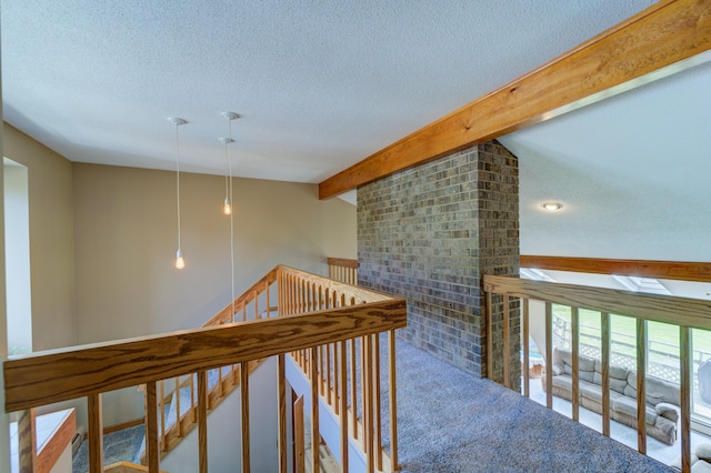 4470 Peach Ridge Ave NW, Grand Rapids, MI 49544 - hallway featuring an upstairs landing, beamed ceiling, a textured ceiling, and a skylight