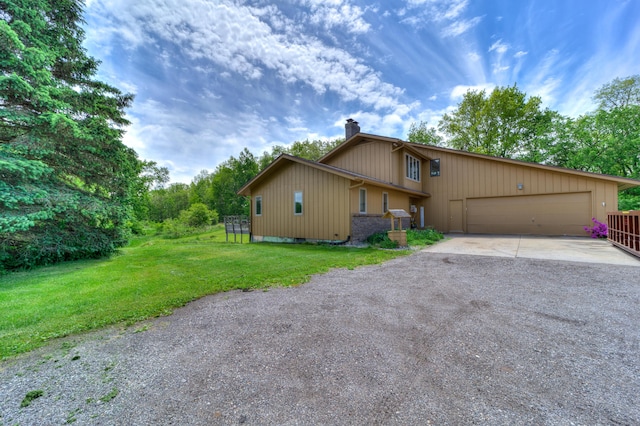 4470 Peach Ridge Ave NW, Grand Rapids, MI 49544 - view of property exterior featuring a chimney, driveway, a yard, and a garage