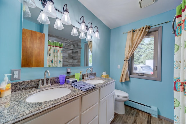 4470 Peach Ridge Ave NW, Grand Rapids, MI 49544 - bathroom with a baseboard heating unit, double vanity, toilet, wood finished floors, and a shower with shower curtain