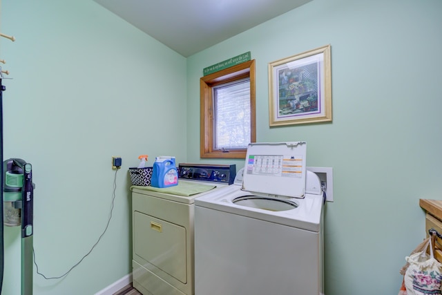 4470 Peach Ridge Ave NW, Grand Rapids, MI 49544 - washroom featuring washing machine and clothes dryer and baseboards