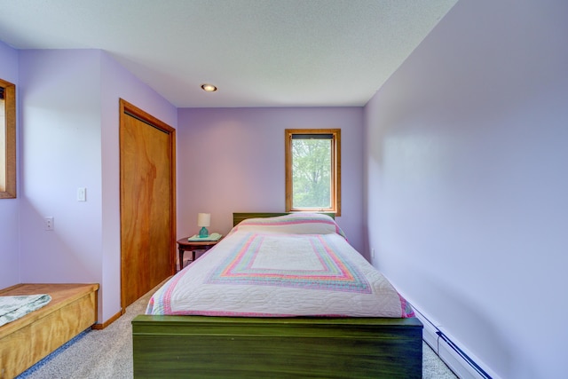 4470 Peach Ridge Ave NW, Grand Rapids, MI 49544 - bedroom featuring carpet flooring, a closet, and baseboard heating
