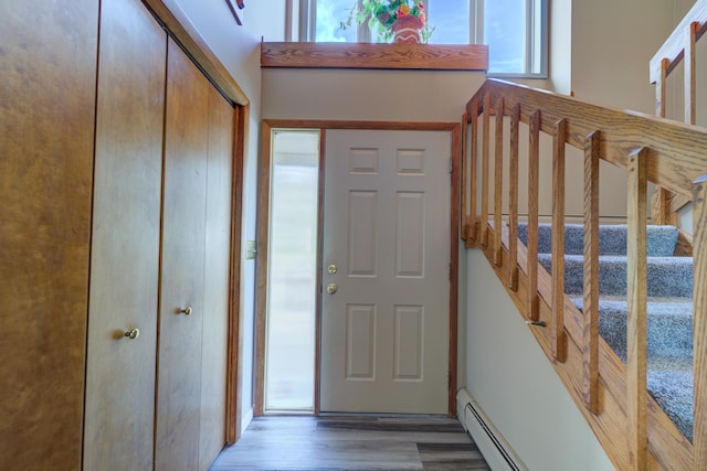 4470 Peach Ridge Ave NW, Grand Rapids, MI 49544 - entrance foyer with wood finished floors, stairs, and baseboard heating