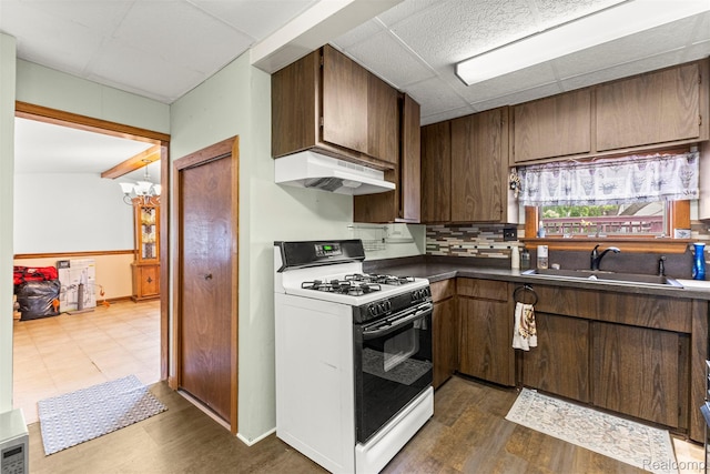 19200 Roger St, Melvindale, MI 48122 - kitchen with range with gas stovetop, a sink, custom exhaust hood, a paneled ceiling, and dark countertops