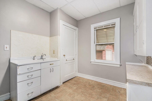 415 Cutler St SW, Grand Rapids, MI 49507 - bathroom featuring baseboards, vanity, and a paneled ceiling