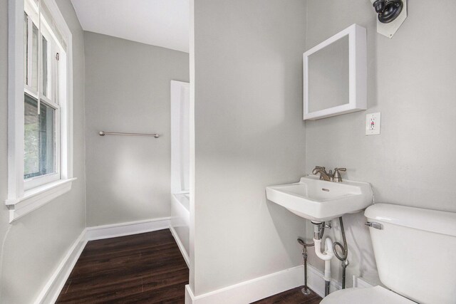 415 Cutler St SW, Grand Rapids, MI 49507 - bathroom featuring toilet, wood finished floors, and baseboards