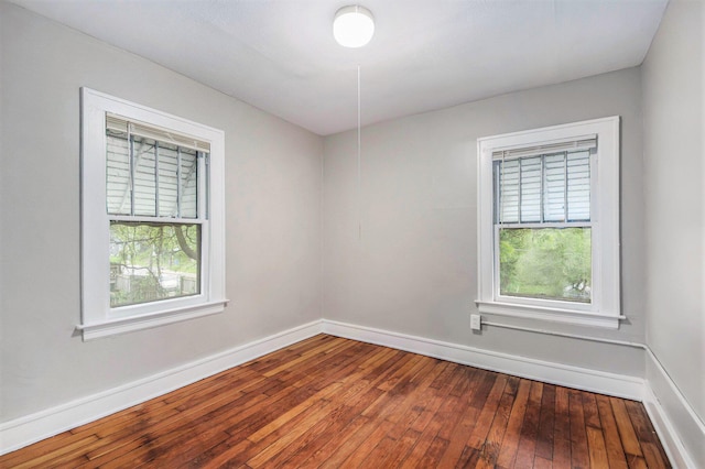 415 Cutler St SW, Grand Rapids, MI 49507 - empty room featuring healthy amount of natural light, wood-type flooring, and baseboards