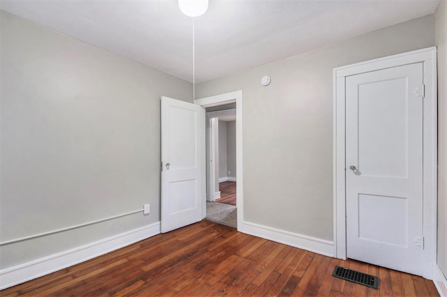 415 Cutler St SW, Grand Rapids, MI 49507 - unfurnished bedroom featuring hardwood / wood-style flooring and baseboards