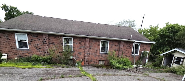 487 E Elizabeth St, Stockbridge, MI 49285 - view of home's exterior with brick siding and roof with shingles