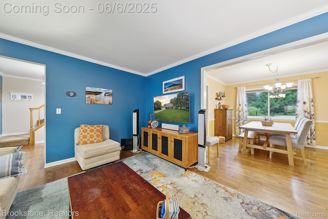 2831 Aurora Dr, Lake Orion, MI 48360 - living area with wood finished floors, a chandelier, ornamental molding, baseboards, and stairway