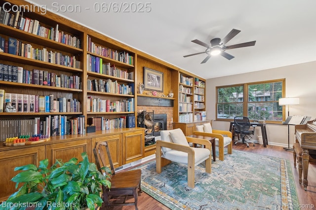 2831 Aurora Dr, Lake Orion, MI 48360 - sitting room with a ceiling fan, wood finished floors, a fireplace, and baseboards