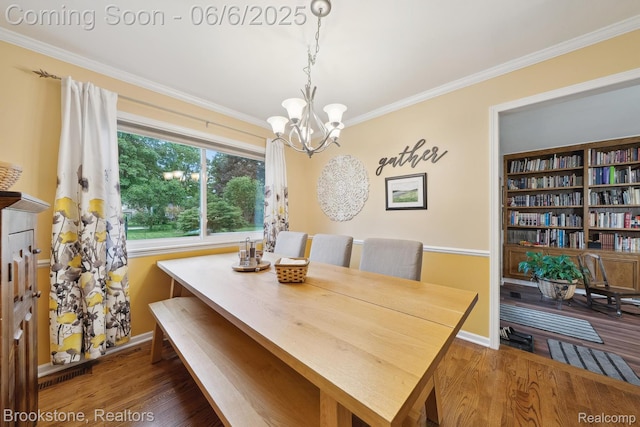 2831 Aurora Dr, Lake Orion, MI 48360 - dining space featuring a chandelier, crown molding, wood finished floors, and baseboards