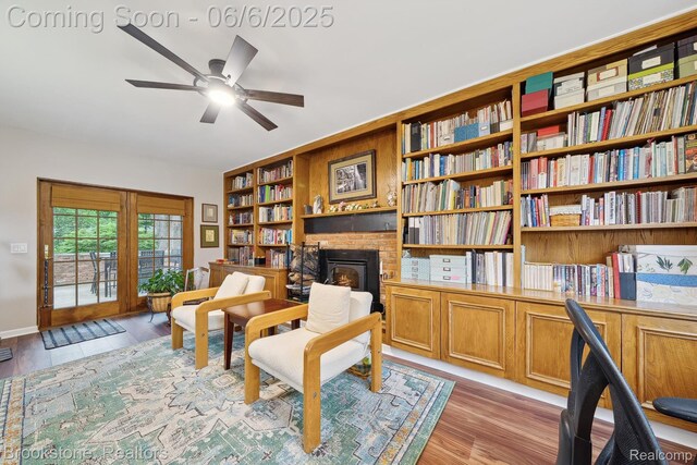 2831 Aurora Dr, Lake Orion, MI 48360 - living area with a brick fireplace, a ceiling fan, light wood-style floors, and baseboards