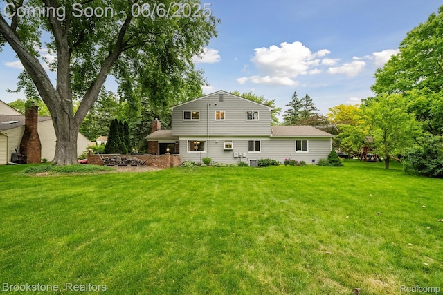 2831 Aurora Dr, Lake Orion, MI 48360 - back of property with a yard and a chimney