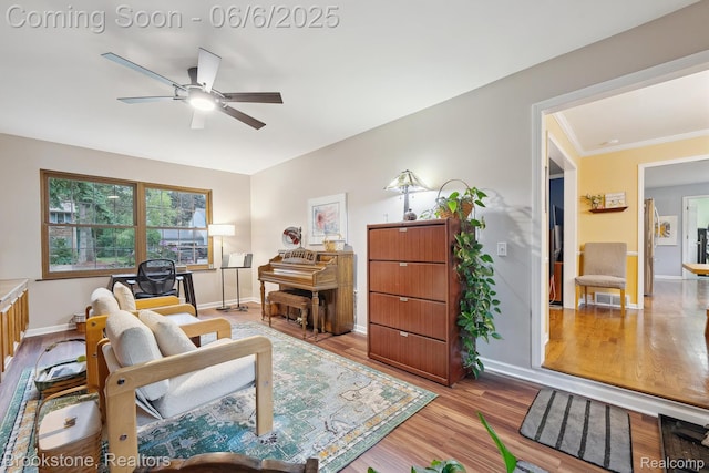 2831 Aurora Dr, Lake Orion, MI 48360 - living area featuring a ceiling fan, wood finished floors, baseboards, and crown molding